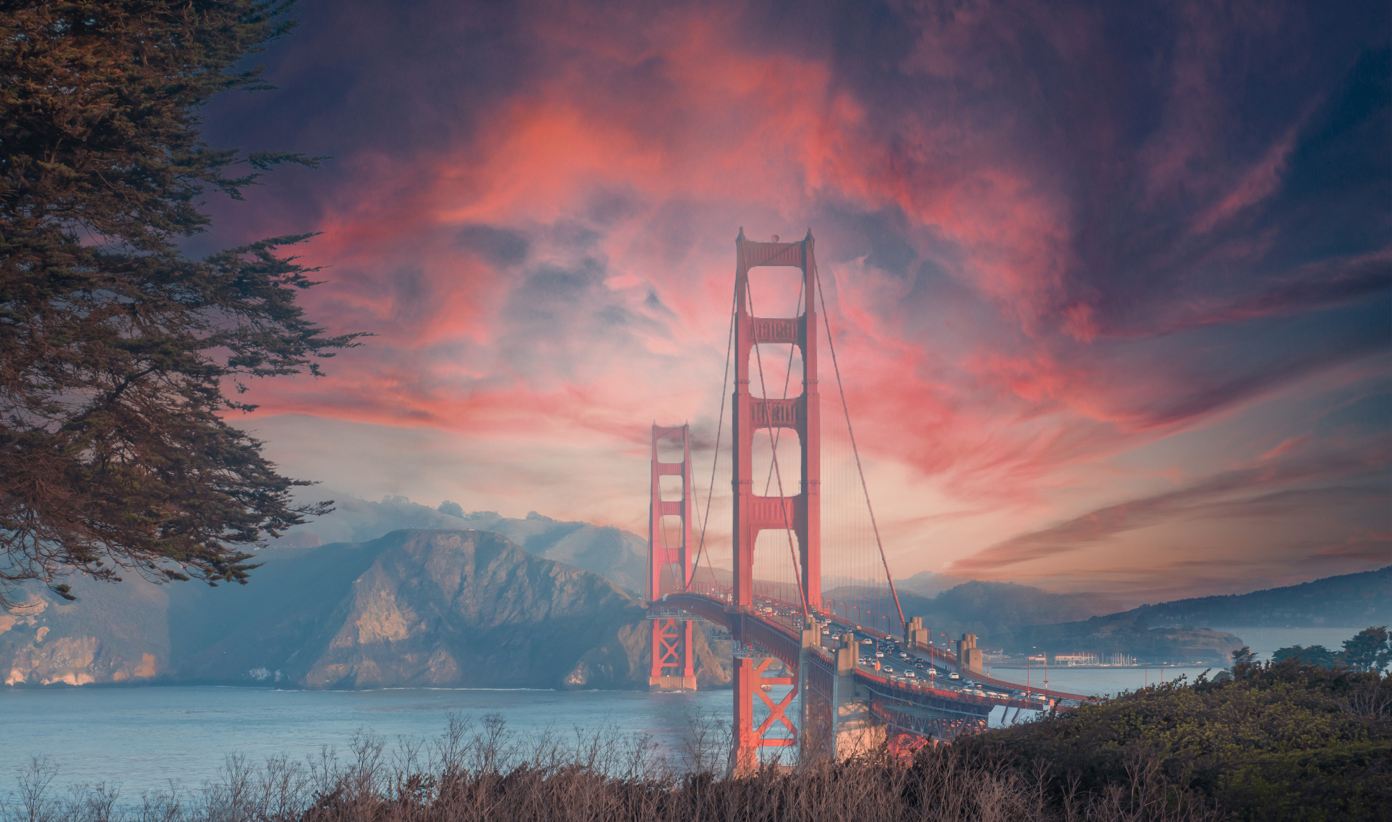 Photomural Beautiful View Of Golden Gate Bridge In Background Of Mountains During Sunset