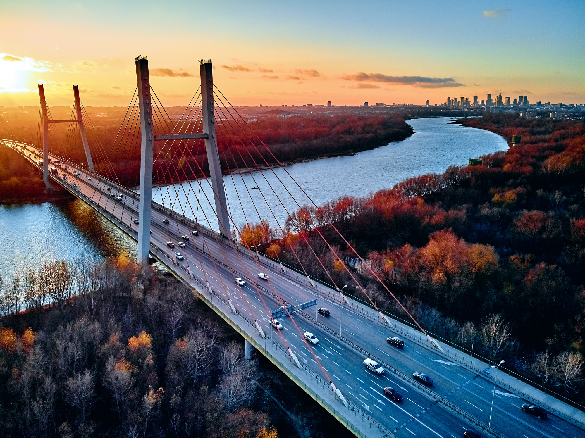 Photomural Beautiful Panoramic Aerial Drone View To Cable-Stayed Siekierkowski Bridge Over The Vistula River And Warsaw City Skyscrapers, Poland In Gold Red Autumn Colors In November Evening At Sunset